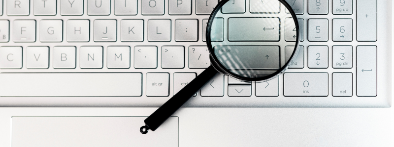 top down picture of keyboard with magnifying glass